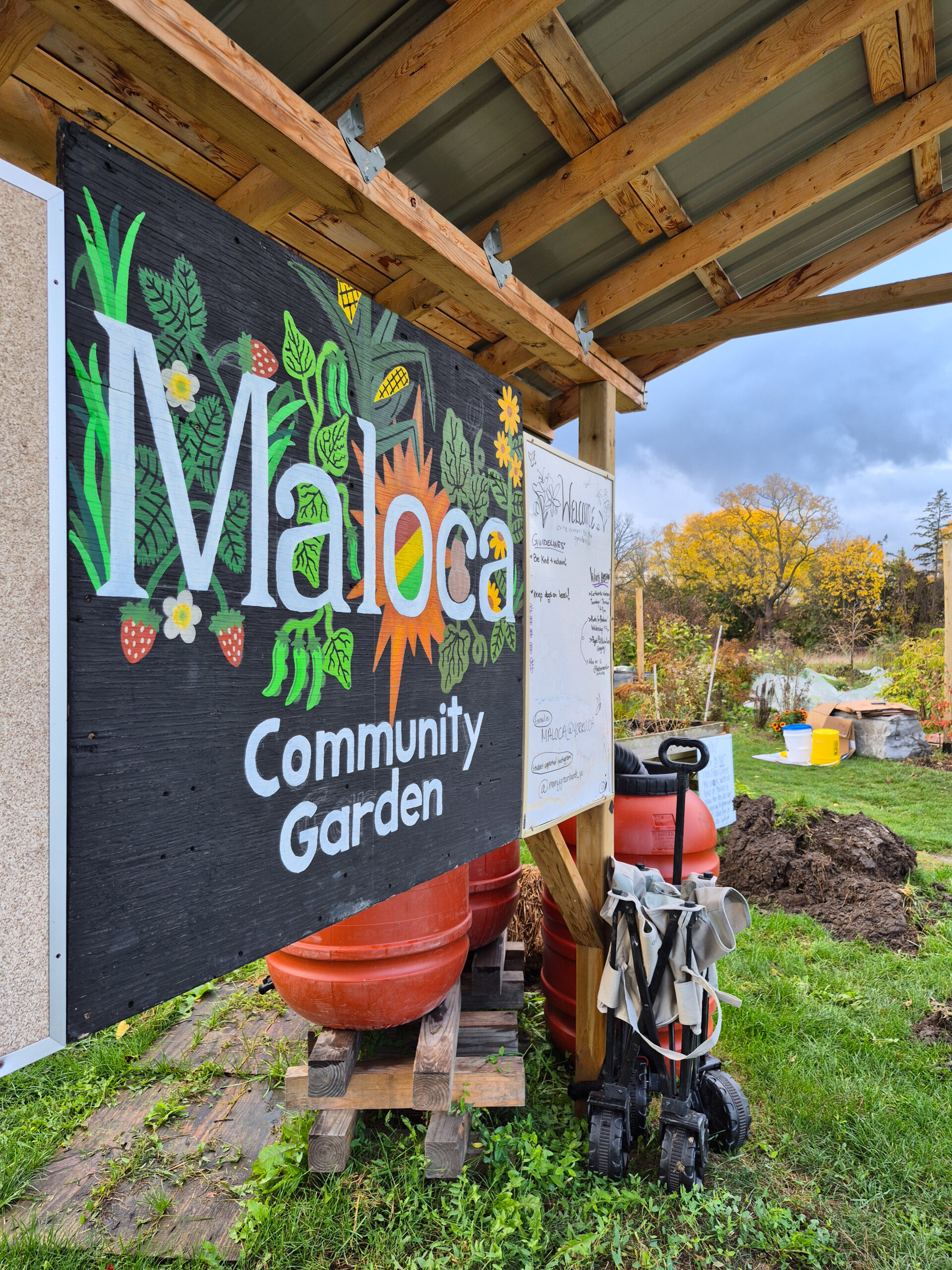 A sign in front of a community garden that reads "Molaca Community Garden."